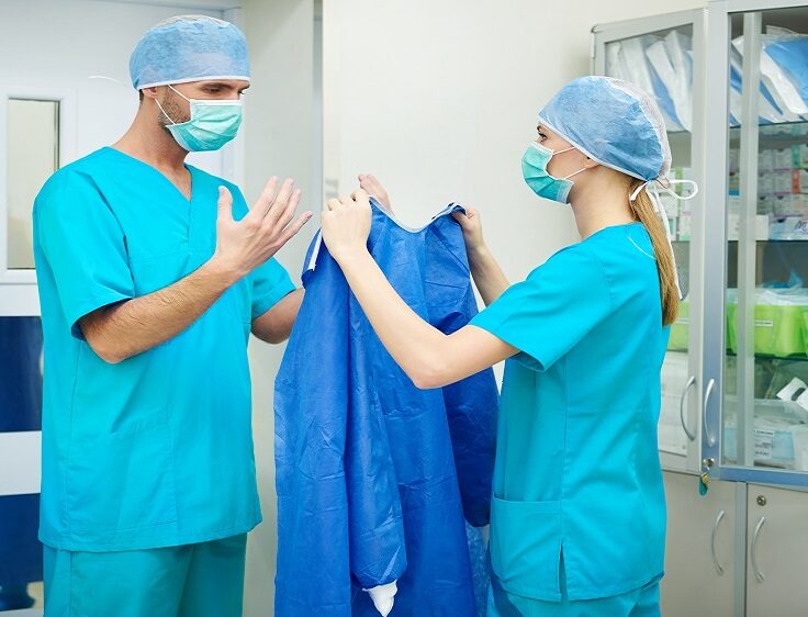 Nurse helping surgeon before the operation